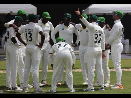 Members of  the  Jamaica Scorpions team get ready to take the field against the Windward Islands Volcanoes in last season’s West Indies Championship encounter at the Brian Lara Cricket Academy in Trinidad.