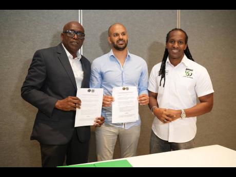 Paulton Gordon (left) President, Jamaica Basketball Association, Avshalom Filler Technical Director, Stella Azzurra Basketball Academy  and Alando Terrelonge (right), State Minister in the Ministry of Culture, Gender, Entertainment and Sport, at the signin