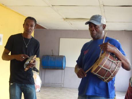 Grater player Jovan Brown (left) and Donald Jackson, seen here with his rattling drum. Jackson also plays the flute.