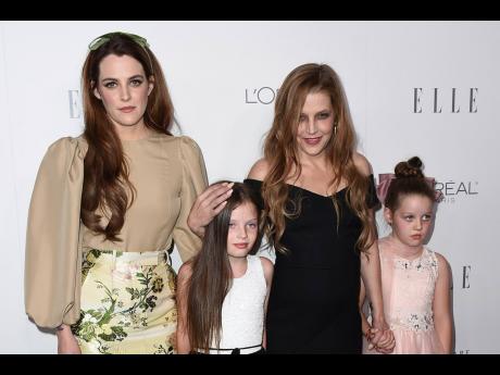 Lisa Marie Presley (second right), her daughter Riley Keough (left), and her twin daughters Finley Lockwood and Harper Lockwood.