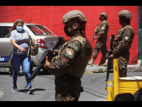 In this March 2022 photo, soldiers man a checkpoint at the entrance to the Las Palmas community, a neighbourhood that is supposedly under the control of Barrio 18 Gang in San Salvador.