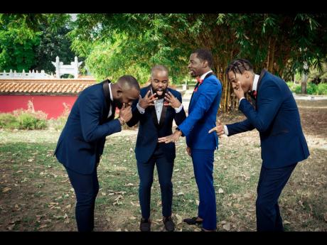 The groomsmen couldn’t help but marvel over the amazing wedding ring. They are (from left): Fabian Archer, best man Stephen Taylor, the groom and Peter Scott.