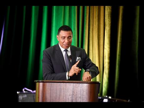 Prime Minister Andrew Holness points to his watch, indicating that the time has come for the transformation of the country’s waste management system into the production of energy, a process of which all Jamaicans can be proud.