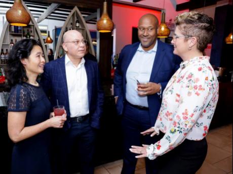 Jeffrey Hall (second left) and his wife, Dr Swee Chua (left), engage in conversation with Scotia Group Jamaica senior leaders, (from left) Gary Vaughn White, director, collateral protection, Caribbean, Central America and Uruguay; and Debra Lopez Spence, p