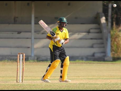 Jamaica U15 opener Tyson Gordon watches a ball carefully during his innings of 48 against the Young Genius Cricket Academy at Chedwin Park on Saturday.