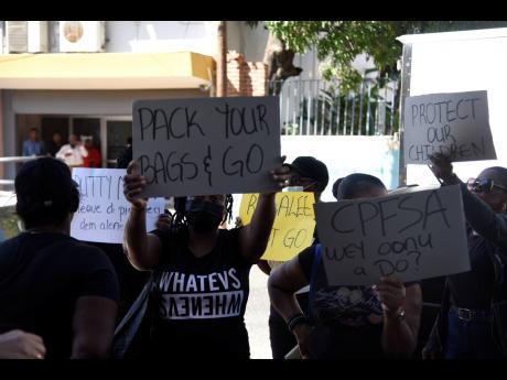 Demonstrators gather outside the Duke Street, Kingston, headquarters of the Child Protection and Family Services Agency on Tuesday demanding the resignation of CEO Rosalee Gage-Grey.