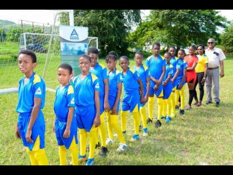 Members of the Gibraltar Primary School’s football team in Discovery Bauxite’s mining area in St Ann, proudly display their uniforms donated by the company for participation in the INSPORTS St Ann division of the all-island primary schools’ football 
