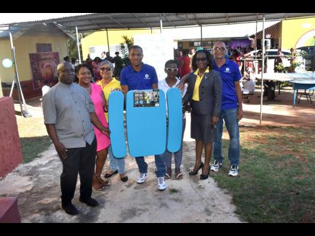 The JN Circle Santa Cruz presented tables and chairs to Bull Savannah Primary and Infant School in St Elizabeth, recently. The furniture will outfit an open air lunchroom which caters to some 40 students. Making the presentation to Collin Cameron (left), p