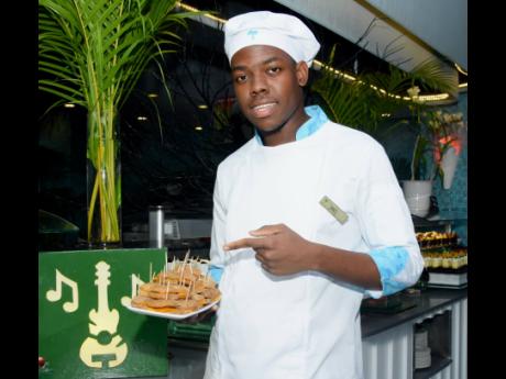 Daniel Davidson poses with bulla and cheese, which was on the menu of the Reggae Kulcha Explosion event for Couples Tower Isle 45th anniversary last Saturday.