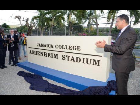 Prime Minister Andrew Holness (right) shortly after the unveiling of a monument for the Ashenheim Stadium on February 20, 2019. Also in photo are Michael Ashenheim (second left), benefactor of the stadium; Ruel Reid (left), the then minister of education, 