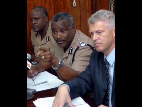 In this October 2005 photograph, then Police Commissioner Lucius Thomas addresses journalists during a press conference at his Old Hope Road, St Andrew, offices. He is flanked by Mark Shields (right), then deputy commissioner, and Linval Bailey, then actin
