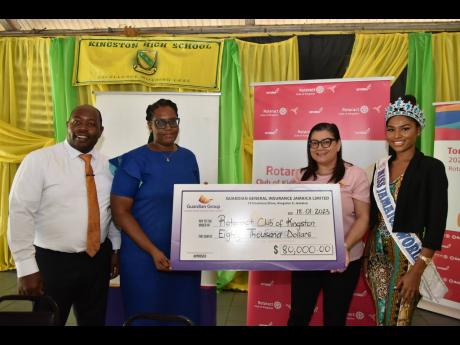 President of the Rotaract Club of Kingston, Toni-Moy Stewart (second left), receives a cheque for $80,000 from Sheraley Bridgeman, vice president of customer experience and marketing, Guardian General. They were joined by Jermaine Loutin, principal of King