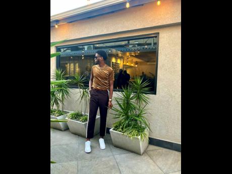 Stepping away from the typical black and blues, Kevaun Merchant pairs his brown tailored pants with a cool bronze-coloured T-shirt.