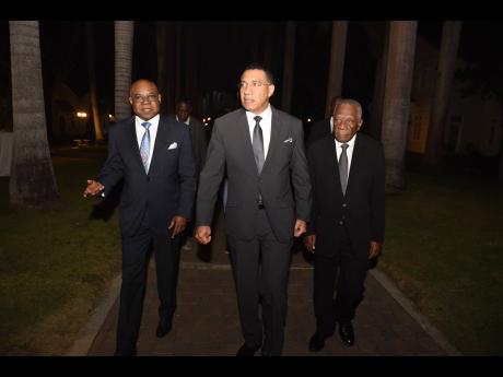 Prime Minister Andrew Holness (centre) is escorted by Tourism Minister Edmund Bartlett (left)  and Godfrey Dyer, chairman of the Tourism Enhancement Fund, to the East Central St James Education Fund’s 25th anniversary dinner, held at the Half Moon Confer