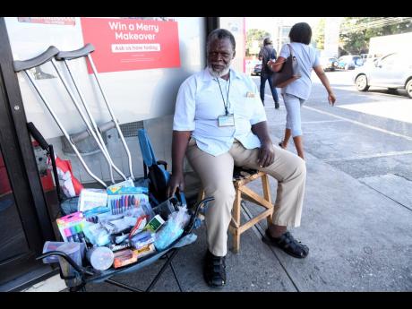 Depending on crutches to move around, Mecheck Willis usually sits at the same place on the sidewalk near the drive-thru exit at the Half-Way Tree Road branch of Scotiabank from Mondays to Fridays, from early morning to late evening, trying to make a living