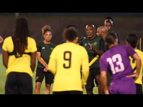 
Reggae Girlz coach Lorne Donaldson speaks with his charges during a training session at the National Stadium.