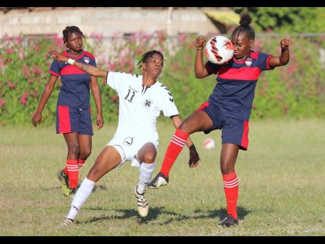 Royal Lakes defender Roshida Somers (right) keeps a close eye on the ball as she is closely marked by Frazsiers Whip attacker Jessica Johnson during last Saturday’s Jamaica Women’s Premier League game at the Royal Lakes Sports Complex in St Catherine. 