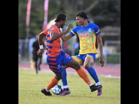 Montego Bay United’s Nevaun Turner  (left) is wrong-footed by Harbour View’s Garth Stewart during yesterday’s Jamaica Premier League match at the Ashenheim Stadium, Jamaica College. 