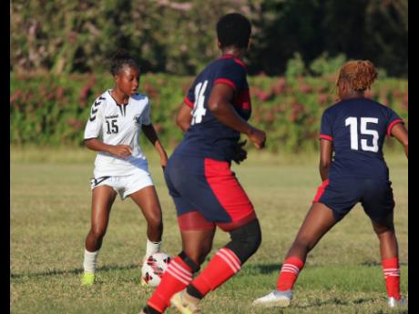  Frazsiers Whip star player Shaniel Buckley (left) is watched carefully by two Royal Lakes defenders during their Jamaica Women’s Premier League match at the Royal Lakes Sports Complex last Saturday. 