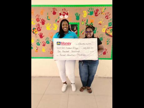 Sanya Wallace, (left) Assistant General Manager at JN Money Services Limited, recently presented a cheque of $100,000 to Deandra Brown, Family Facilitator at SOS Children’s Village in Stony Hill, St. Andrew.