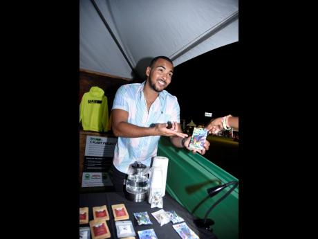 Brian Bailey, the owner of Moon Shot Medicine, giving information on the benifits of his goods on display at the Herb Curb at Reggae Salute.
