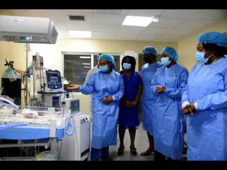 Dr Britton Aiken (left) and other healthcare personnel give State Minister Juliet Cuthbert-Flynn (second right) a tour of the neonatal high-dependency unit at the Victoria Jubilee Hospital on September 25, 2020. A 2022 report of special-care nurseries at V