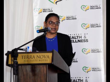 Chief Medical Officer Dr Jacquiline Bisasor-McKenzie gives a presentation Tuesday at the Terra Nova Hotel on the findings of a PAHO report on neonatal deaths at hospital special-care nurseries.