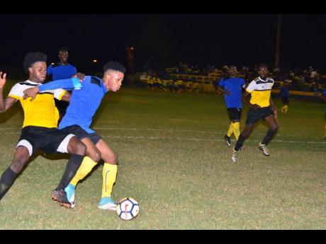 Tevoy Colespring (second left) of Meadforest FC holds off Barbican FC’s Damian English during their Magnum KSAFA Super League first-round clash at Constant Spring Complex in 2020.