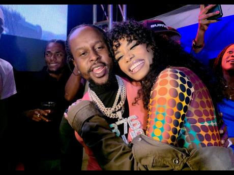 Dancehall superstar Popcaan (left) and beauty queen Toni-Ann Singh were emulating their song ‘Next To Me’, perhaps?