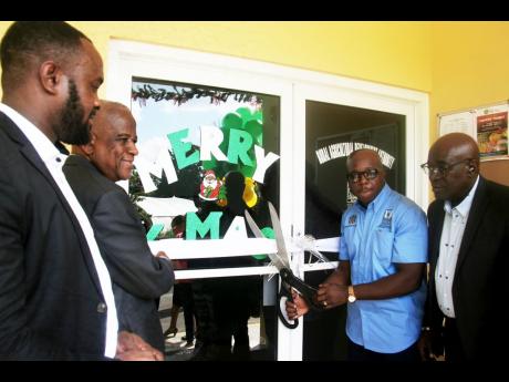 Minister of Agriculture and Fisheries, Pearnel Charles Jnr (2nd right) prepares to cut the ribbon to officially declare open the newly constructed RADA office in Lucea, Hanover.  Looking on are, from left; Mayor of Lucea, Sheridan Samuels, Minister of Stat