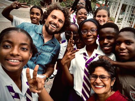 Cairol poses with students of Campion College in 2020. The musician taught the students the basics of music composition and improving their songwriting skills.