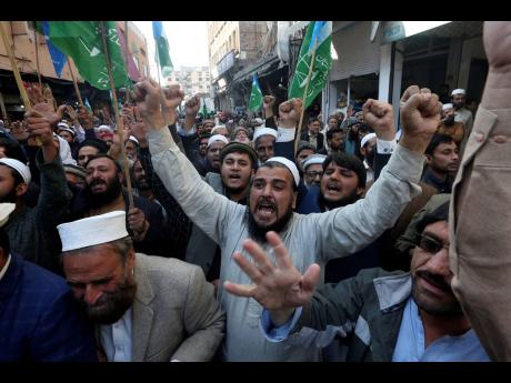 Supporters of Jamaat-e-Islami chant slogans during a protest against the burning of Quran, a Muslim holy book, by a Danish anti-islam activist, in Peshawar, Pakistan yesterday.