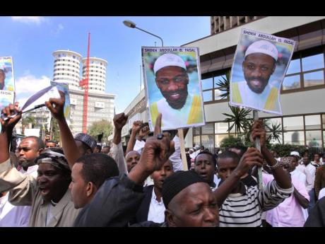 Placards showing Sheik Abdullah el-Faisal are held up by demonstrators in Nairobi, Kenya on January 15, 2010, protesting the arrest of the radical Jamaican-born Muslim cleric who was jailed because Kenyan authorities said he was a threat to the security of