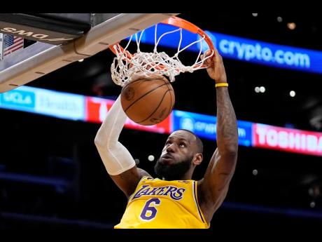 Los Angeles Lakers forward LeBron James dunks during the first half of an NBA basketball game against the San Antonio Spurs on Wednesday, January 25, 2023, in Los Angeles. 