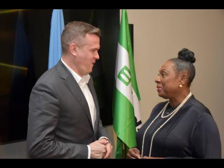 World Anti-Doping Agency president Witold Banka (left) speaks with Minister of Culture, Gender, Entertainment and Sport Olivia Grange at the end of the Jamaica Anti-Doping Commission’s annual symposium yesterday. The two-day symposium was held at the AC 