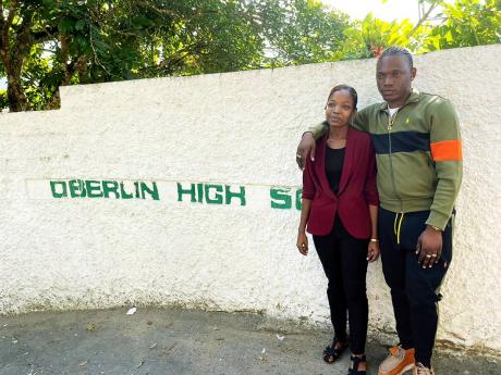 Dancehall artiste Valiant (right) and Antoinette Gray, acting vice-principal of Oberlin High School. 