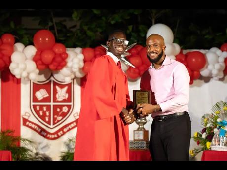 Daniel Miller, 2019 “Spirit of ‘86” awardee, (left) receives the “True Campionite” Award at his graduation ceremony in summer 2022.