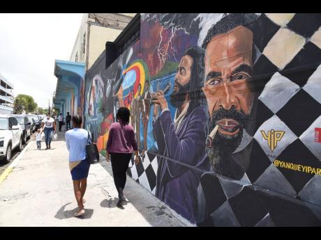 Murals on wall along Church Street in downtown Kingston spruce up the space.