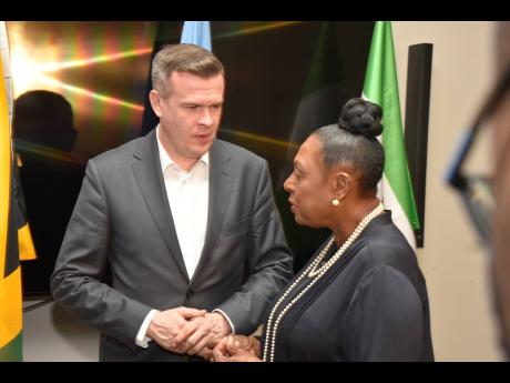 
President of WADA, Witold Banka, speaks with The Honourable Olivia Grange, minister of culture, gender, entertainment and sport, after an anti-doping news conference at the AC Hotel, Lady Musgrave Road, St Andrew, on Friday.
