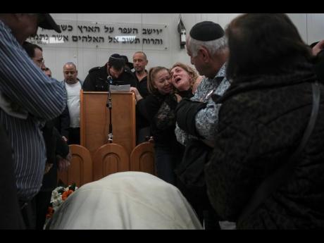 Mourners attend the funeral of Rafael Ben Eliyahu, a victim of a shooting attack Friday in east Jerusalem, at Givat Shaul cemetery in Jerusalem, Sunday today. On Friday a Palestinian gunman opened fire outside an east Jerusalem synagogue, killing Ben Eliya