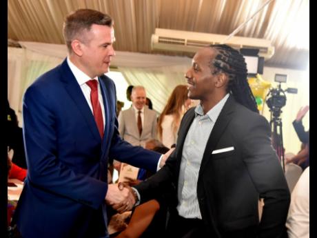 Witold Banka (left), president of the World Anti-Doping Agency, is greeted by Alando Terrelonge, state minister in the Ministry of Culture, Gender, Entertainment and Sport, at the Terra Nova Hotel last Thursday, on the opening day of  the 2023 Jamaica Anti
