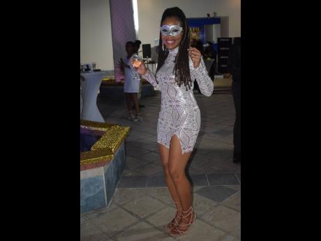 Putting her dancing feet to work and looking lovely while doing so is a masked Imega Breese McNab, executive director of the PSOJ. 