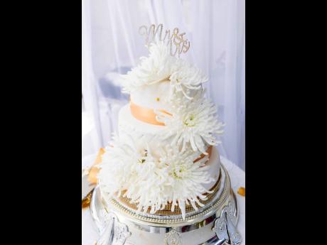 The wedding cake was embellished in gold-toned jewels and flowers.