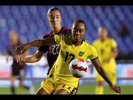 Jamaica’s Allyson Swaby (right) and Mexico’s Diana Ordonez battle for the ball during a Concacaf Women’s Championship football match in Monterrey, Mexico on Monday, July 4, 2022. 