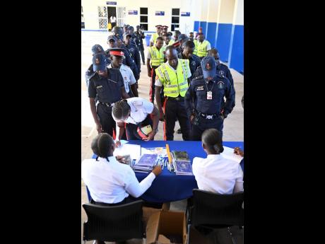 Police personnel registered for a conference on the new Road Traffic Act and regulations ahead of the opening ceremony at the National Police College of Jamaica in Twickenham Park, St Catherine, Monday.