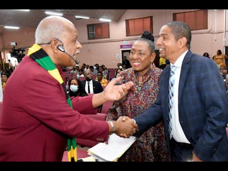 Minister of Culture, Gender, Entertainment and Sport Olivia Grange (centre), and Mayor of Kingston Delroy Williams (right), are greeted by Reverend Merrick ‘Al’ Miller, pastor of Fellowship Tabernacle in Kingston during the 2023 Reggae Month Church Ser