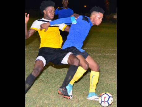 Tevoy Colespring (right) of Meadforest FC holds off Barbican FC’s Damian English during their Magnum KSAFA Super League first round clash at Constant Spring Complex in 2019. 