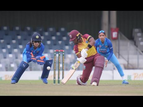  West Indies captain Hayley Matthews plays a cover drive during her innings top score of 34 against India in the sixth match of the T20 Tri-Series in East London, South Africa. Looking on are wicketkeeper Yastika Bahtia and captain Harmanpreet Kaur.