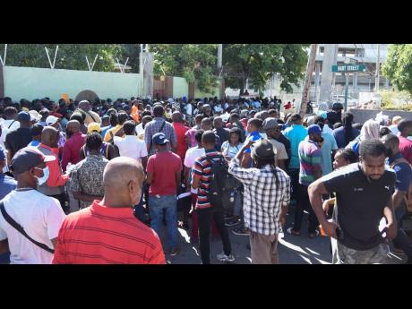 Hours before the end of a partial amnesty, hundreds of people swarm the road outside the Kingston and St Andrew Traffic Court on Tuesday. The new Road Traffic Act takes effect today.