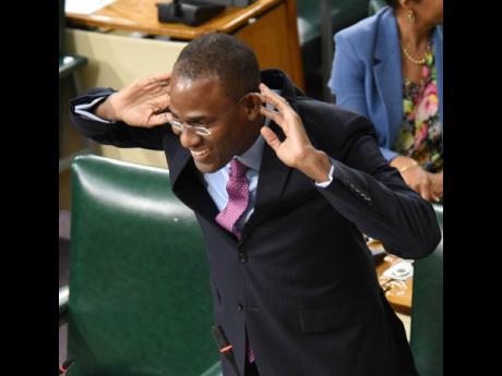 Dr Nigel Clarke, minister of finance and the public service, makes a playful gesture after tabling in the House of Representatives the Third Supplementary Estimates for fiscal year 2022-2023.